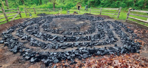 The final product, charcoal, has cooled and is ready for transport to the charcoal house. Photo, Suzanne Reisser