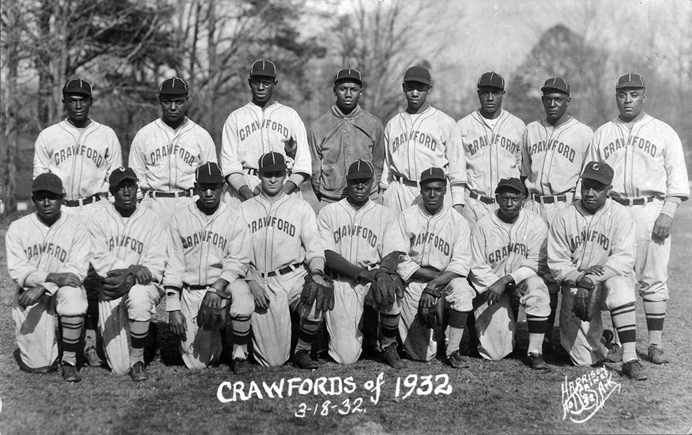 The 1932 Pittsburgh Crawfords are, standing from left to right, Benny Jones, L.D. Livingston, Satchel Paige, Josh Gibson, Ray Williams, Walter Cannady, Cy Perkins and Oscar Charleston. Kneeling in front are Sam Streeter, Chester Williams, Harry Williams, Harry Kincannon, Henry Spearman, Jimmie Crutchfield, Bobby Williams and Ted "Double Duty" Radcliffe. Wikimedia Commons