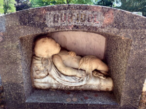 A sculpture of Taylor’s infant daughter Rebe was incorporated into the design of her headstone. Photo, Spencer Larson
