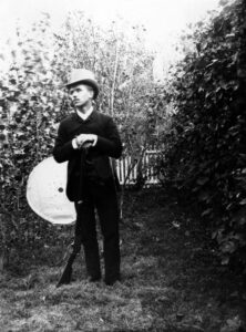 George Landis remained at the Landis Valley farmstead for his entire life and avidly collected firearms, in addition to the many other artifacts the brothers accumulated. Here he stands with a Winchester rifle, about to test it. Landis Valley Village & Farm Museum, Pennsylvania Historical & Museum Commission