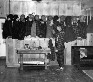 Woolrich started making its red-plaid, woolen outdoors clothing 22 years before this 1947 camp photo was taken. Known among hunters as the “Pennsylvania Tuxedo,” it was considered the warmest clothing available. It remained popular well into the 1980s. Pennsylvania Game Commission