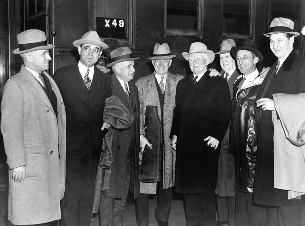 The Garner Pack meet up at the train station in Washington, D.C., in 1937. From left, they are Sen. Harry Truman, Sen. Sherman Minton, Sen. Joe Guffey, unidentified man, Vice President John Nance Garner, Sen. Clyde Herring, Sen. Carl Hatch, and Sen. James Murray. Harry S Truman Presidential Library