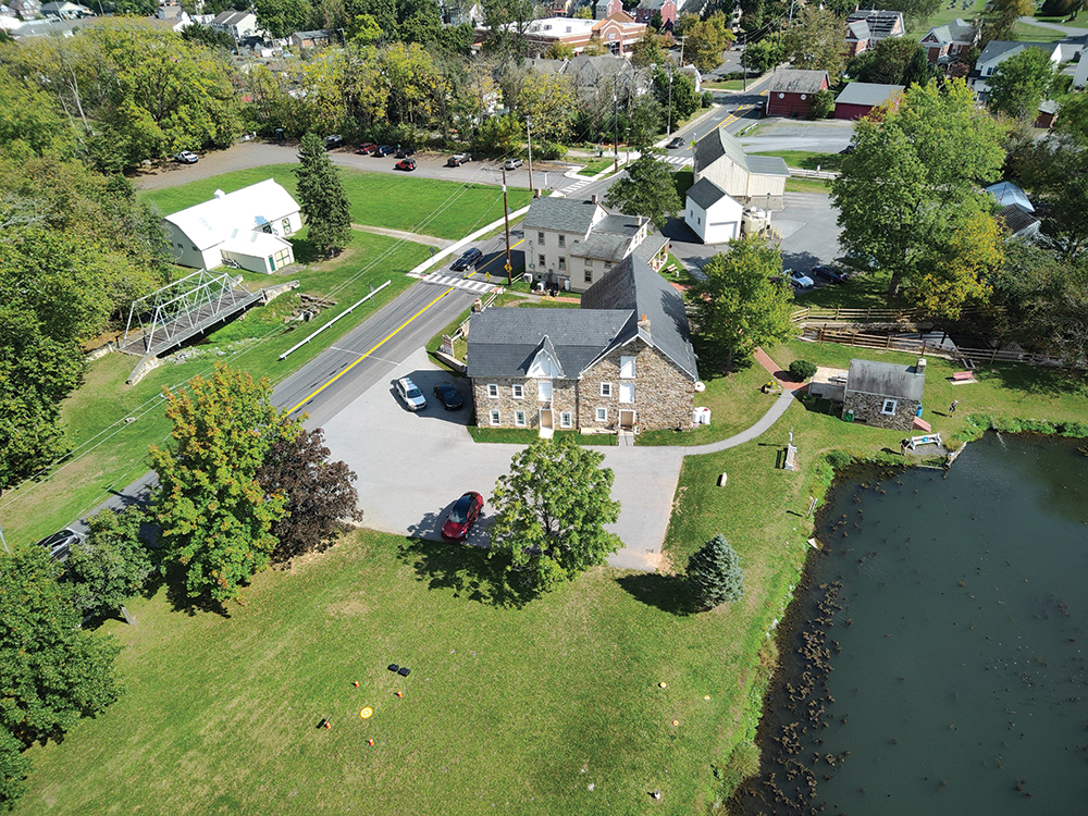 The Heller–Wagner Grist Mill property from above, with the mill at center, the wash house to the right, and the miller’s house, barn and shed in back. Hellertown Historical Society